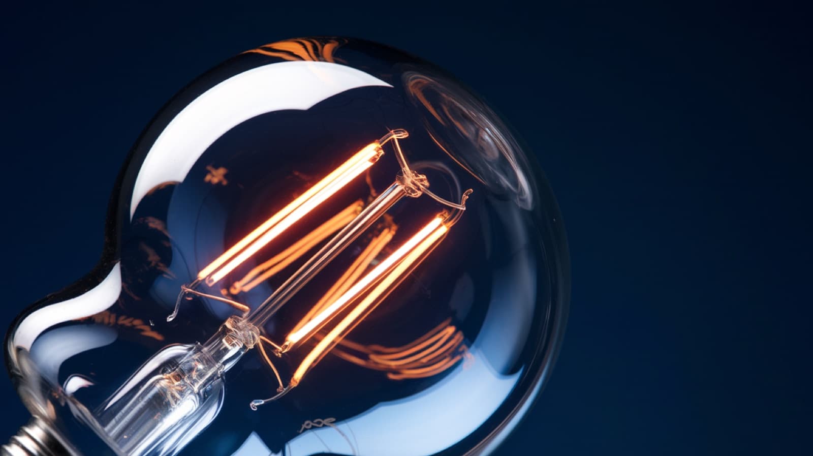 A glowing filament lamp, the kind filled with inert argon gas