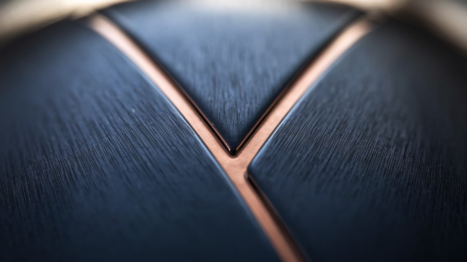 Brushed navy steel with an inlaid copper seam